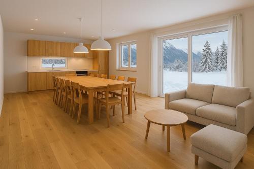 a kitchen and dining room with a table and a couch at Chalet Villa Hera in Bichlbach