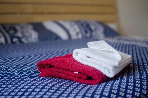 a pile of towels sitting on top of a bed at Apartmany a Ubytovani Mlynice Litovel in Litovel