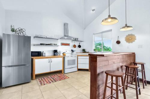 a kitchen with white cabinets and a counter with stools at Canyon Breeze in Canyon Lake