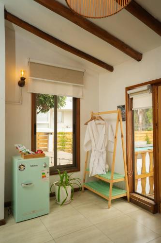 a room with an old refrigerator and a window at Reñaca House Hotel in Viña del Mar