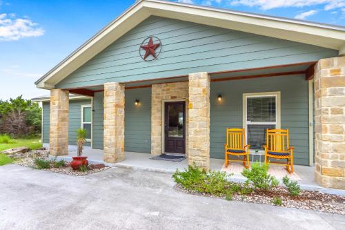 a house with two yellow chairs in front of it at Canyon Breeze in Canyon Lake