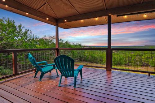 two chairs sitting on a deck with a view at Canyon Breeze in Canyon Lake