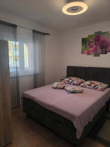 a bedroom with a bed with purple sheets and pillows at Apartment Snježana in Crikvenica