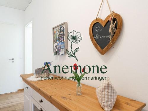 a room with a counter with a heart sign on the wall at Ferienwohnung Anemone - 4 Zimmer mit Bergblick & Alpenflair in Germaringen