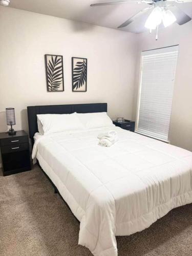 a bedroom with a large white bed with a ceiling at The West House Cozy-Modern-Spacious in Midland