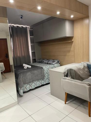 a bedroom with two twin beds and a cabinet at Apartamento com piscina in Ponta Grossa
