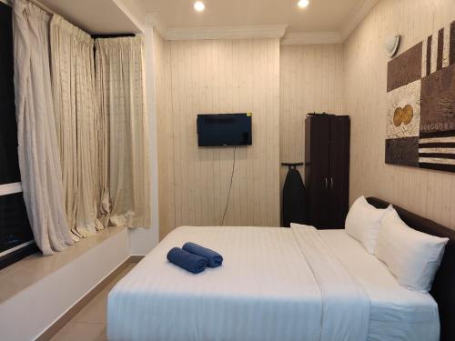 a bedroom with a bed with a blue towel on it at park view Service Apartment near KLCC in Kuala Lumpur