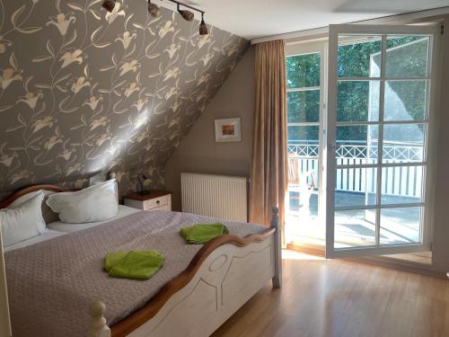 a bedroom with a bed and a sliding glass door at Ferienhaus Prerow an der Stems in Prerow