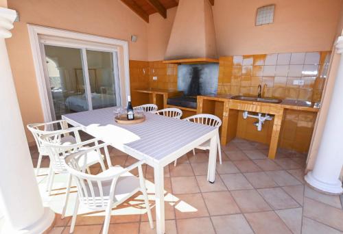 a white table and chairs in a kitchen at Luxury Sea View Villa Oltamar - Single Level - Private Pool - Full Privacy in Calpe