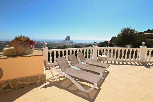 a chair sitting on top of a balcony at Luxury Sea View Villa Oltamar - Single Level - Private Pool - Full Privacy in Calpe