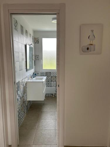 a bathroom with a tub and a sink and a mirror at Casa vacanza Cipria in Olìa Speciosa