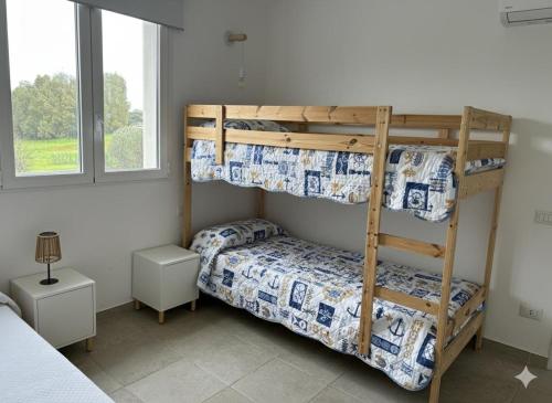 a bedroom with two bunk beds and a bed at Casa vacanza Cipria in Olìa Speciosa