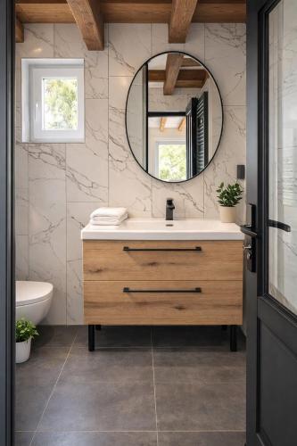 a bathroom with a sink and a mirror at Hôtel De La Promenade in Chevigney