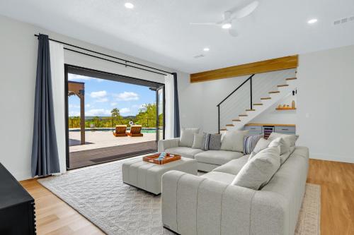 a living room with a white couch and a large window at Jalsa in Wimberley