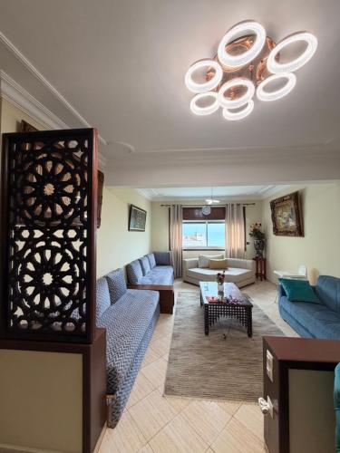 a living room with couches and a ceiling at Entire Ocean-View Apartment in Rabat
