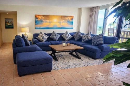 a living room with blue couches and a coffee table at Beachfront Resort with Heated Pool Saida Royale 9039 in South Padre Island