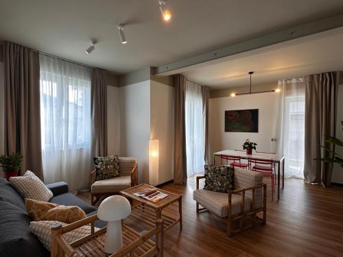 a living room with a couch and chairs and a table at Foresteria 33 in Ghedi