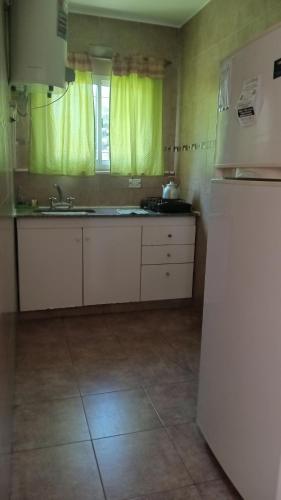 a kitchen with a sink and a refrigerator at Complejo San Eduardo, Chapadmalal in Colonia Chapadmalal