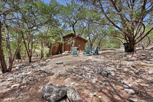 a group of chairs sitting in front of a cabin at Lajitas at The Bend in Wimberley