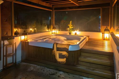 a bath tub in a room with lights and candles at Morada da Lua - Juquitiba in Juquitiba