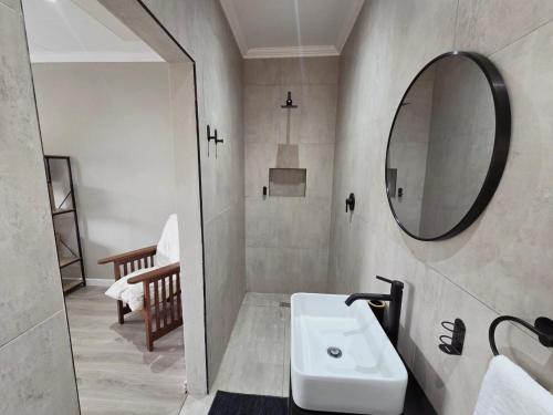 a bathroom with a sink and a mirror at Munnik Rest in Polokwane