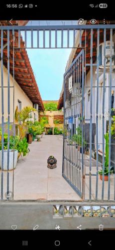 a gate in front of a house with plants at Kitnet 17 in São Luís