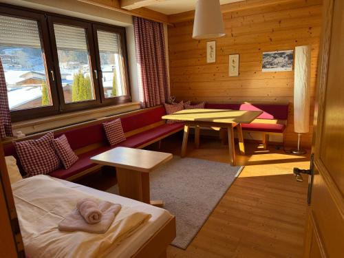 a room with a bench and a table in a cabin at Haus Barbara in Waidring