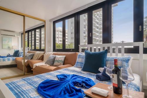 a living room with a bed and a couch at Luxe Beachside Oasis Pool Parking by PH in San Juan
