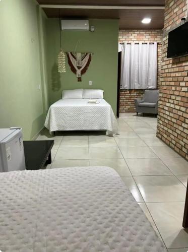 a bedroom with a bed in a room at Lumoa Beach Chalé Tutoia in Tutóia