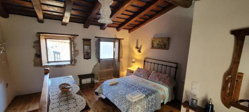 a bedroom with a bed and a table and a window at Casas Quo Vadis -Azul in Lugo