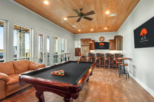 a living room with a pool table and a bar at Lakeside Dreamhouse in Canyon Lake