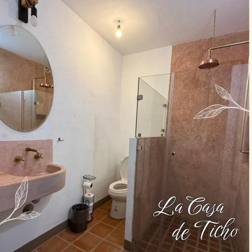 a bathroom with a sink and a shower with a mirror at La Casa de Ticho in Mascota
