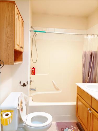 a bathroom with a white toilet and a shower at Cozy Home in Vancouver in Vancouver