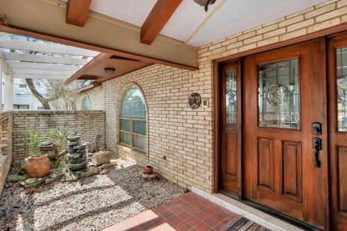 a home with a wooden door and a brick wall at Lakeside Overlook in Canyon Lake