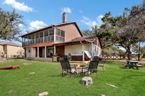 a house with two chairs and a grill in the yard at Lakeside Overlook in Canyon Lake
