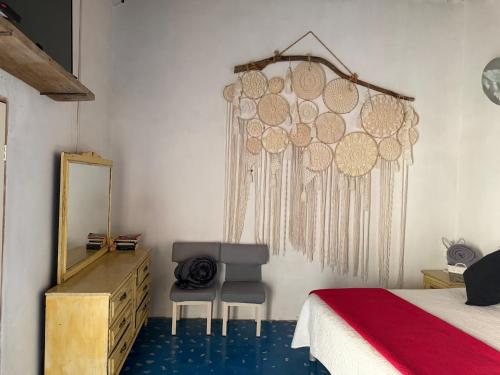 a bedroom with a bed and a mirror and a chair at Casa Díaz Habitacion Diamante in Parras de la Fuente