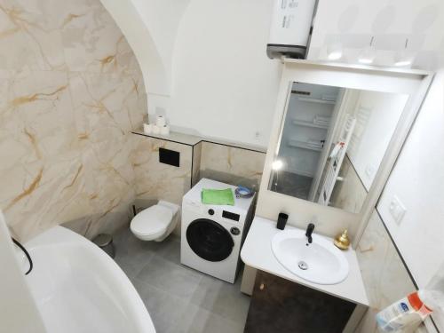 a small bathroom with a sink and a toilet at Alma Apartment DOWNTOWN in Košice