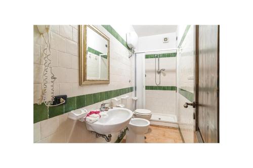 a bathroom with a sink and a toilet at Agriturismo La Fattoria in Ascea