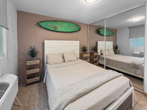 a bedroom with two beds and a mirror at Haudimar Beach Apt Ocean Front With Parking in San Antonio