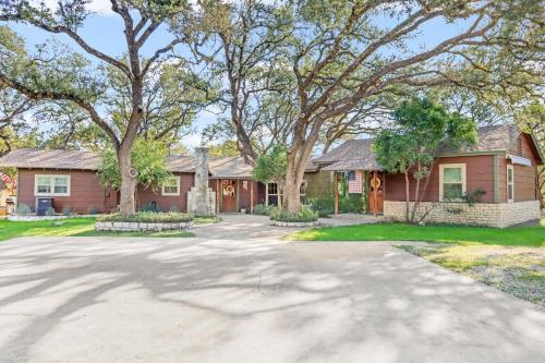 a house with a driveway in front of it at Lawlis Lodge in Wimberley
