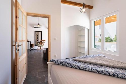 a bedroom with a bed and a window at Apartment Zdravko near centar in Novalja