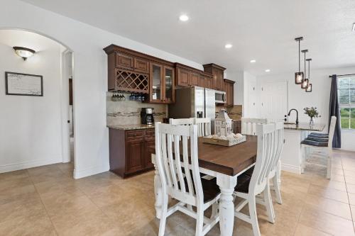 a kitchen and dining room with a wooden table and chairs at Pampered Pillow in Canyon Lake
