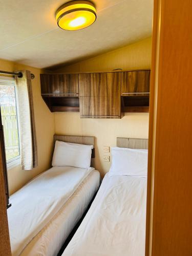 two beds in a small room in a trailer at Edinburgh Lux Lodge Seton Sands in Port Seton