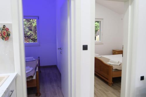a room with a bed and a bedroom with purple walls at Casa Bellora in Donja Jošica