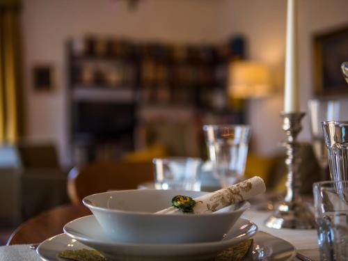 a table with a white bowl on a table at Apartment "Maria Theresia" in Graz