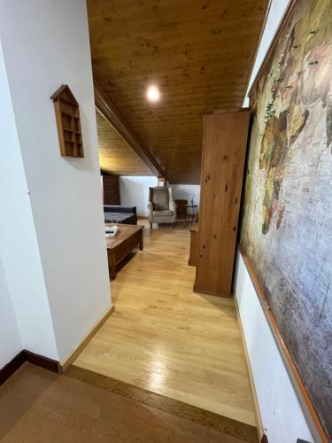 a hallway with a large painting on the wall at Alojamiento Finca La Campa in Mareo de Abajo