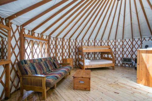 a living room with a couch in a yurt at Yosemite Lakes Yurts in Harden Flat