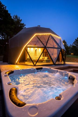 a large tub with a tent in the background at Continental Adventure Resort - Mountain Escape & Glamping in Livno