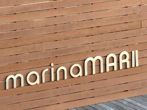a sign on a wooden wall with the word mariani at Marina Mar II - Moradia T3 in Vila Franca do Campo