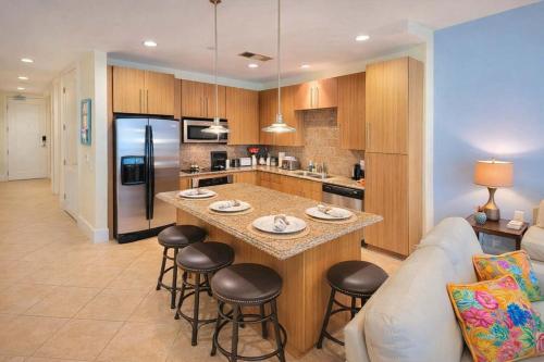 a kitchen with a island in the middle of a living room at Sapphire 1706 home in South Padre Island